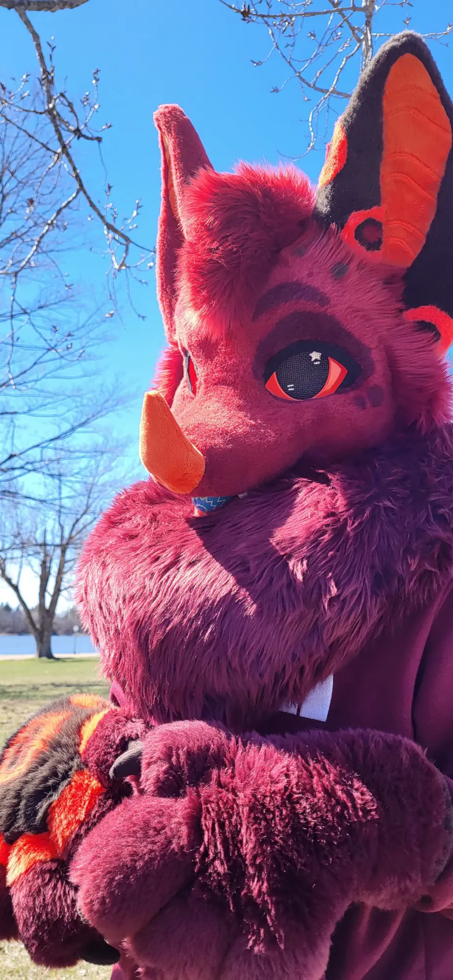 Outside photo of Lazarus Overlook in his red bat fursuit (April 2025).
